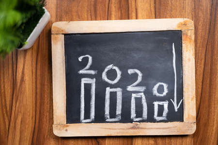 2020 with down word yarrow on slate - concept of things went down during 2020 like business, market, jobs due to pandemicの写真素材