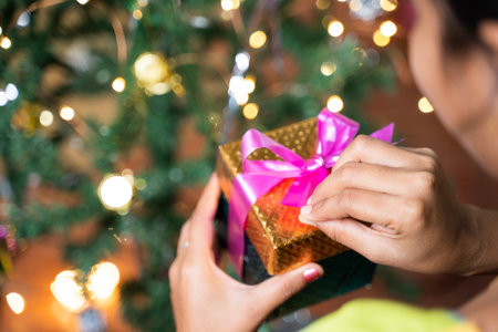 Concept of Self gifting during Holiday Shopping or celebration - Shoulder shot of Girl infront of...