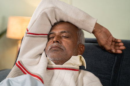 Asian senior man having nice sleep on bed at home - concept of better sleep or nap and healthy lifestyleの写真素材