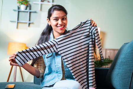 social media influencer promoting by explaining about cosmetic products by looking camera - concept of vlogger product review or live video streaming to generate leadsの写真素材