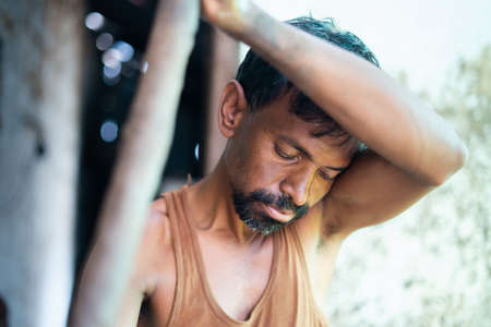 Close up shot of potter Rotating pottery wheel manually by using stick - concept of Indian traditional way of making earthenware and clay pots.の写真素材