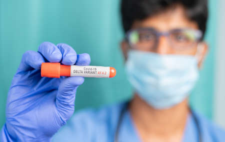 Doctor or nurce showing Blood sample of new Coronavirus or covid varient AY4.2 - cocnept of covid-19...