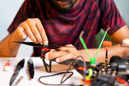 Close up shot of hands instalilng propeller to Quadcopter - concept of drone assemble and reparing UAV.の写真素材