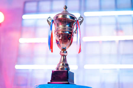 trophy on neon light staged background during e-sports video gaming tournament for winnersの写真素材