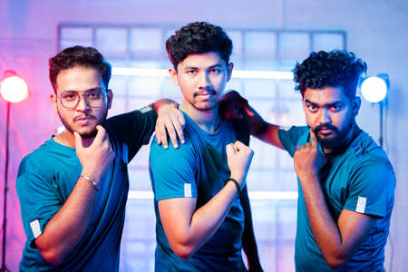 Team of professional gamer on stage or arena in attitude by showing different hand gestures while...