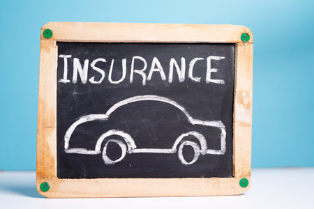 concept of car or vehical insurence showing by placing vehicle insurence sign board on blue backgroundの写真素材