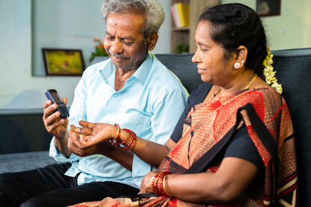 happy Husband after checking sugar level of wife at home - concept of diabetes, bonding and supporting husbandの写真素材