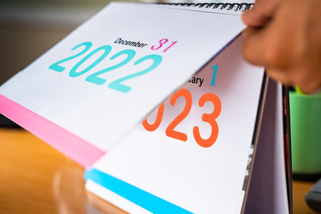 close up handheld shot of change calendar from 2022 to New year January 2023 - concept of fresh or new startの写真素材