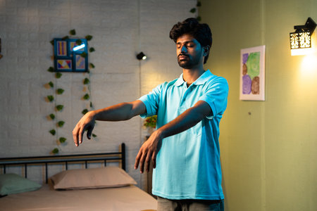 medium shot of young man walking in sleep at bedroom during night at home - concept of sleepwalking, sonamubulate or diseaseの写真素材