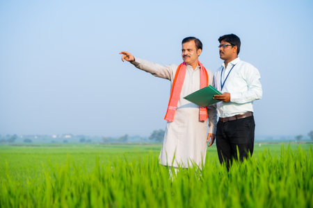 Banker or officer making notes about crop or farmland by asking farmer - concept of agriculture survey, examining and inspection.の写真素材