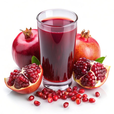 Pomegranate juice in a glass and fresh fruits on a white backgroundの写真素材