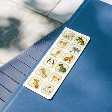 A close up shot of a blue tablecloth with animals on it