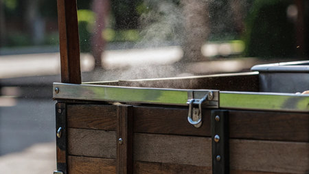 Pouring water from a fountain in the park. Selective focus.