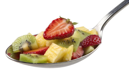 Fruit salad in a spoon on a white background. Isolatedの写真素材