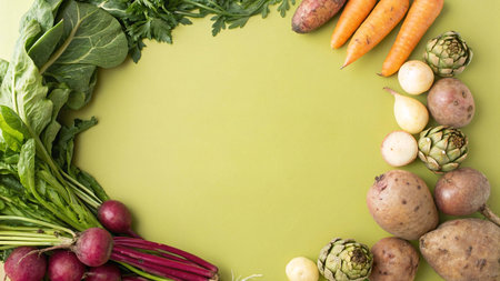 Organic vegetables on green background with copy space. Top view.
