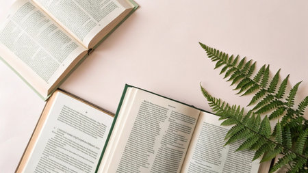 Open book, fern and books on pink background. Top viewの写真素材