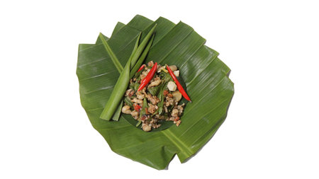 Thai spicy salad on banana leaf isolated on white background with clipping pathの写真素材