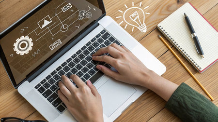 businesswoman hand working on laptop computer with business icons and light bulb
