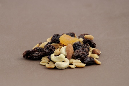 Mixed nuts and dried fruits on brown backgroundの写真素材