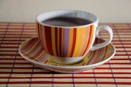 Large red, yellow, purple and orange striped coffee mugの写真素材