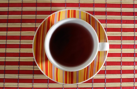 Large red, yellow, purple and orange striped coffee mugの写真素材