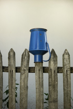 Milk jug on a fenceの写真素材