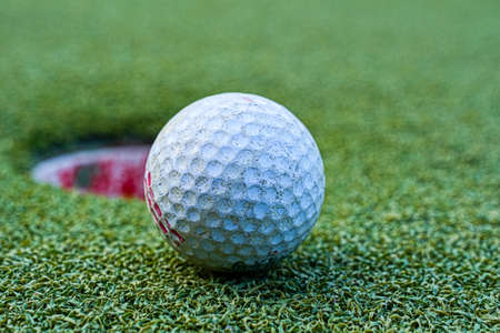 closeup shot of the golf course on a green lawn with a blurred backgroundの写真素材