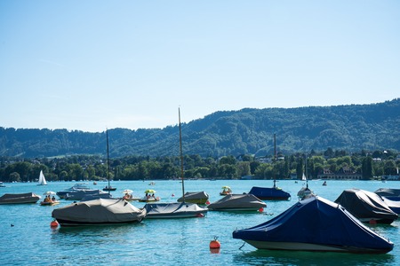 boat on lake zurich in summer with uetliberg in the back