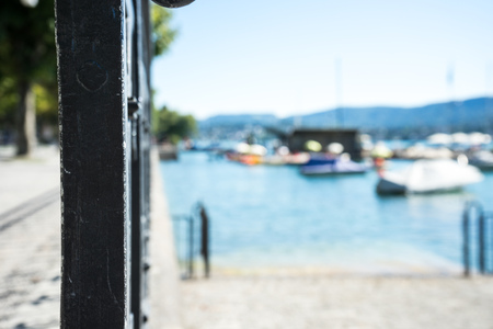 Old craftet iron fence with lake view and boatの写真素材