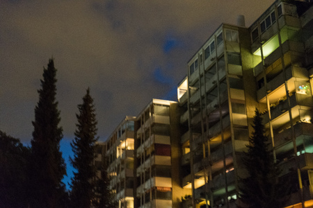 house night with lights on and violet cloudy sky illuminationの写真素材