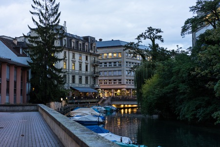 street scene with boats on canal at blue hour and water reflection