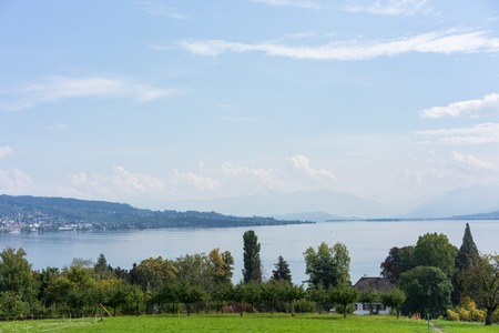 landscape of lake zurich in summer with buildings from hiking trail switzerland tourism travel destinationの写真素材