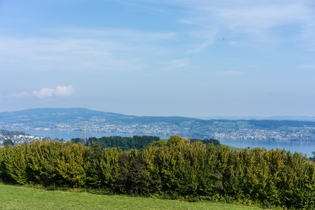 landscape of lake zurich in summer with tree line hiking trail switzerland tourism travel...
