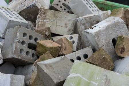 concrete bricks construction material laying in skip on each other heapの写真素材
