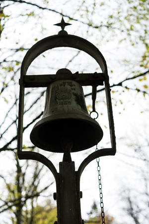 metal iron bell in park historic antique graveyardの写真素材