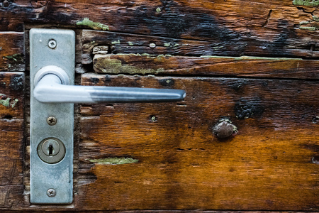 old historic door handle on wood doorの写真素材