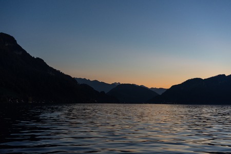 sunset at lake lucerne with mountains viewed from boatの写真素材