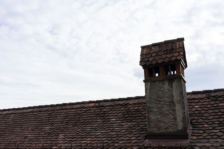 chimney on roof with cloudy skyの写真素材