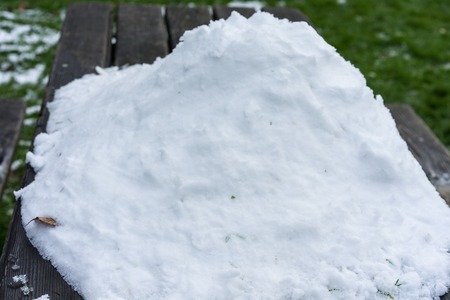pile of snow on wood table outdoorの写真素材