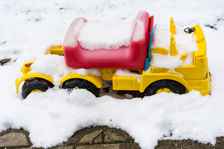 bobby car covered in snowの写真素材