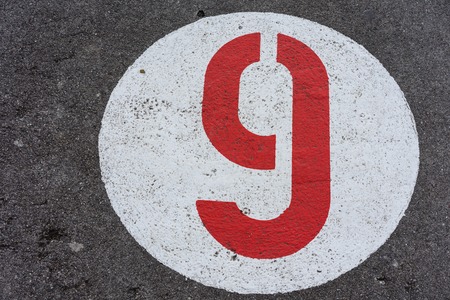red number nine in white circle road signの写真素材