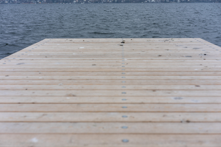 wood deck on lake zurich in winter with water