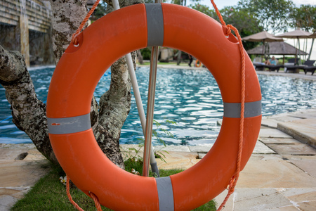 Marine lifebuoy on fence, near swimming poolの写真素材