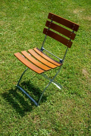 singe brown chair outside in meadowの写真素材