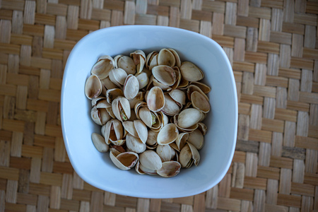 healthy nuts close up view on wooden zig zag table, high angle viewの写真素材