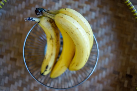 fruit in bucket, ripe yellow banana ready to eatの写真素材
