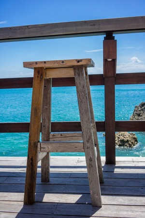 Empty wood chairs with ocean view, holiday mood