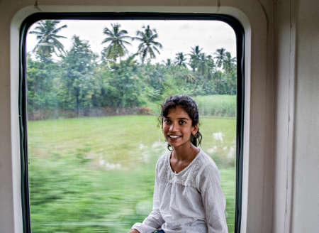 Kottavalasa, Andhra Pradesh, India:August 28th, 2017-Young  girl enjoying the ride of vistadome train coach on way to scenic Araku valley.のeditorial素材