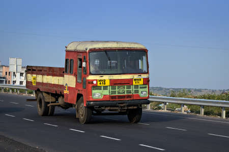 Pune, Maharashtra, India- October 25th, 2016: State transport open truck speeding on highway.のeditorial素材