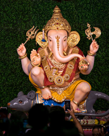 Close up portrait view of decorated and garlanded  idol of Hindu God Ganesha in Pune ,Maharashtra,...
